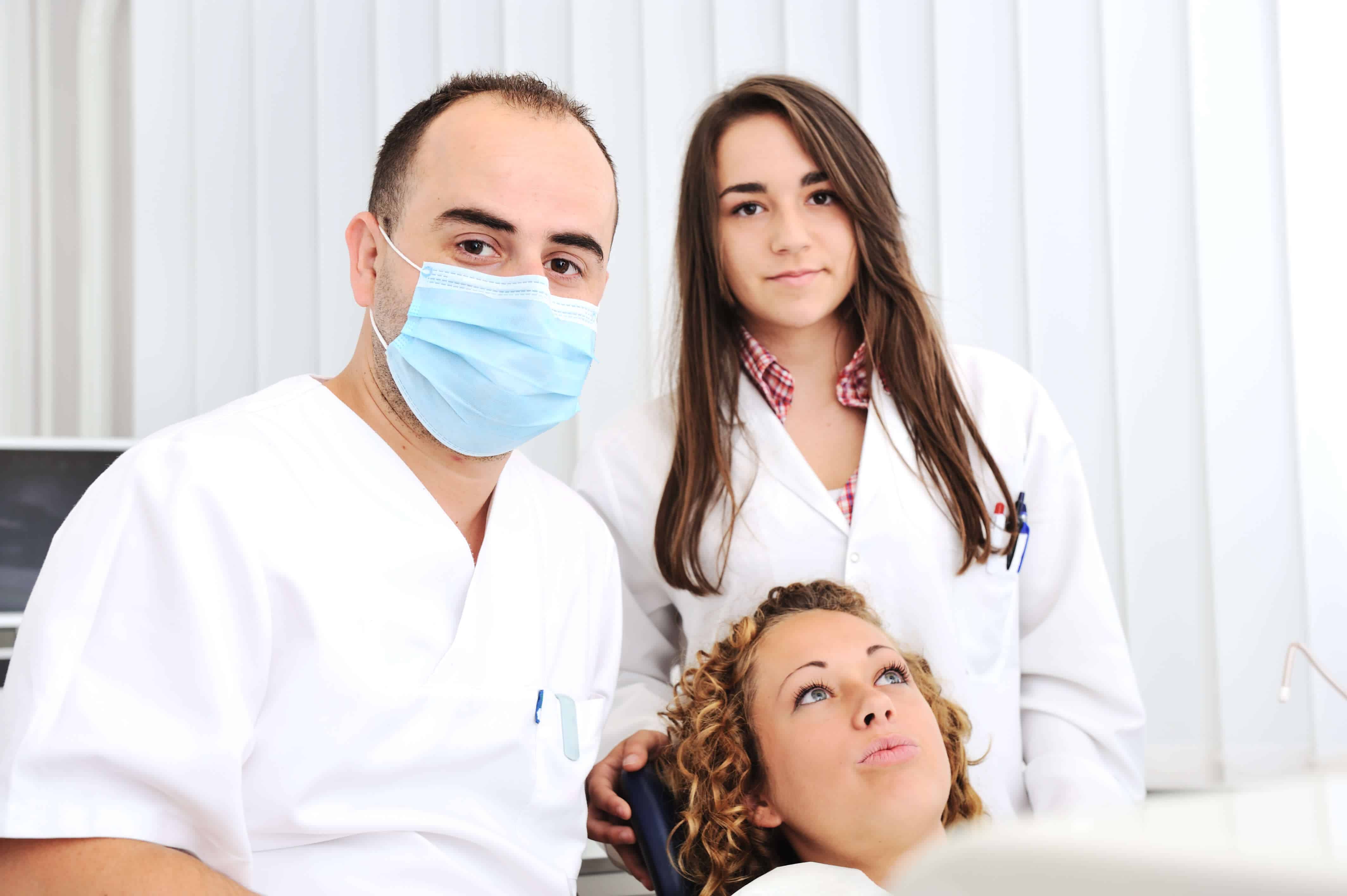 downtown dentistry dentists with patient - oral surgery toronto by downtown dentistry