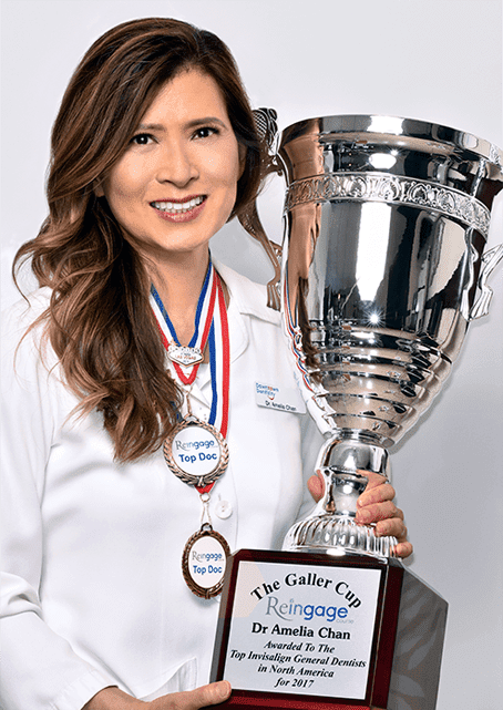 dr. chan holds trophy - toronto dentists by downtown dentistry