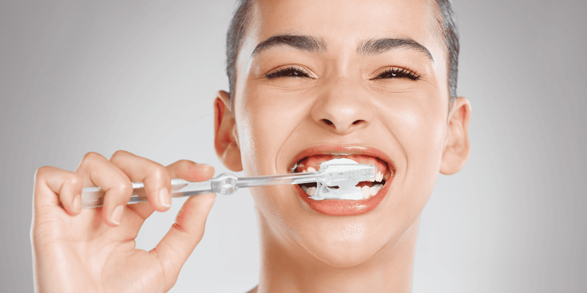 Young lady observing oral hygiene by brushing